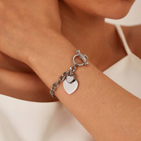 Amore Stainless Steel Heart Bracelet with Cubic Zirconia Heart Charm worn on model's wrist — Waterproof, Hypoallergenic & Tarnish Free | Forever Amalfi Steel Range | Amalfi Lane