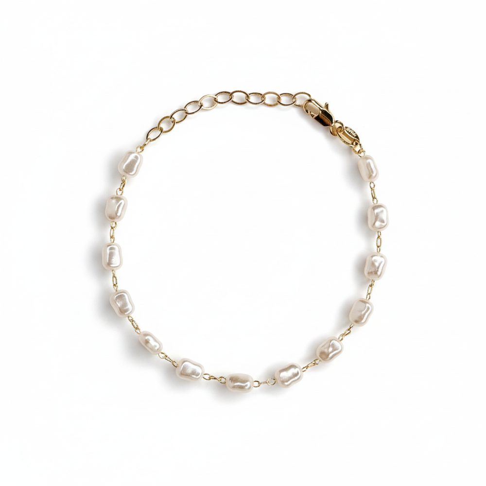 Bionda 18K gold-filled bracelet with creamy white simulated baroque pearls and an adjustable extender on a studio-white background