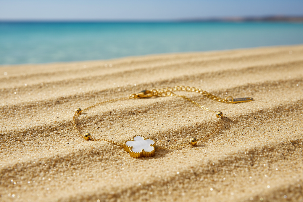 Fiorella 18K Gold Plated White Flower Bracelet - Bracelet on Rippled Sand with Beach in the Background | Amalfi Lane