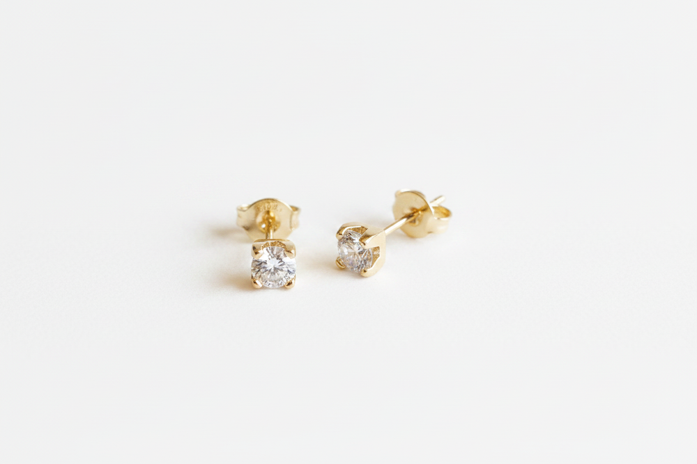 Milena 18K Gold-Filled 4mm CZ Solitaire Stud Earrings angled view on white studio background showing 4-prong setting — Amalfi Lane
