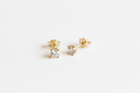 Milena 18K Gold-Filled 4mm CZ Solitaire Stud Earrings angled view on white studio background showing 4-prong setting — Amalfi Lane
