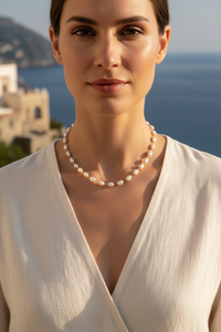 Model wearing the Bionda 18K gold-filled simulated baroque pearl necklace on the Amalfi Coast