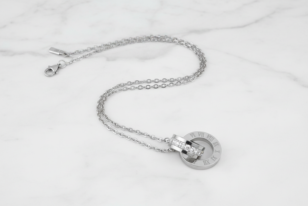 Prima Donna Stainless Steel Cubic Zirconia Necklace - laying flat on a marble bench | Amalfi Lane