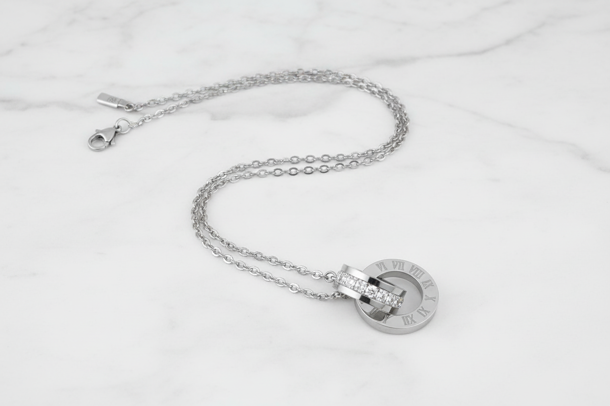 Prima Donna Stainless Steel Cubic Zirconia Necklace - laying flat on a marble bench | Amalfi Lane