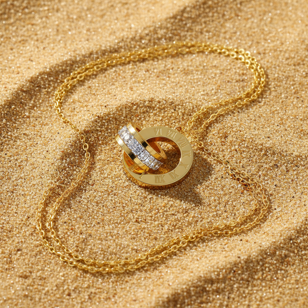 Prima Donna gold necklace flat lay on sand